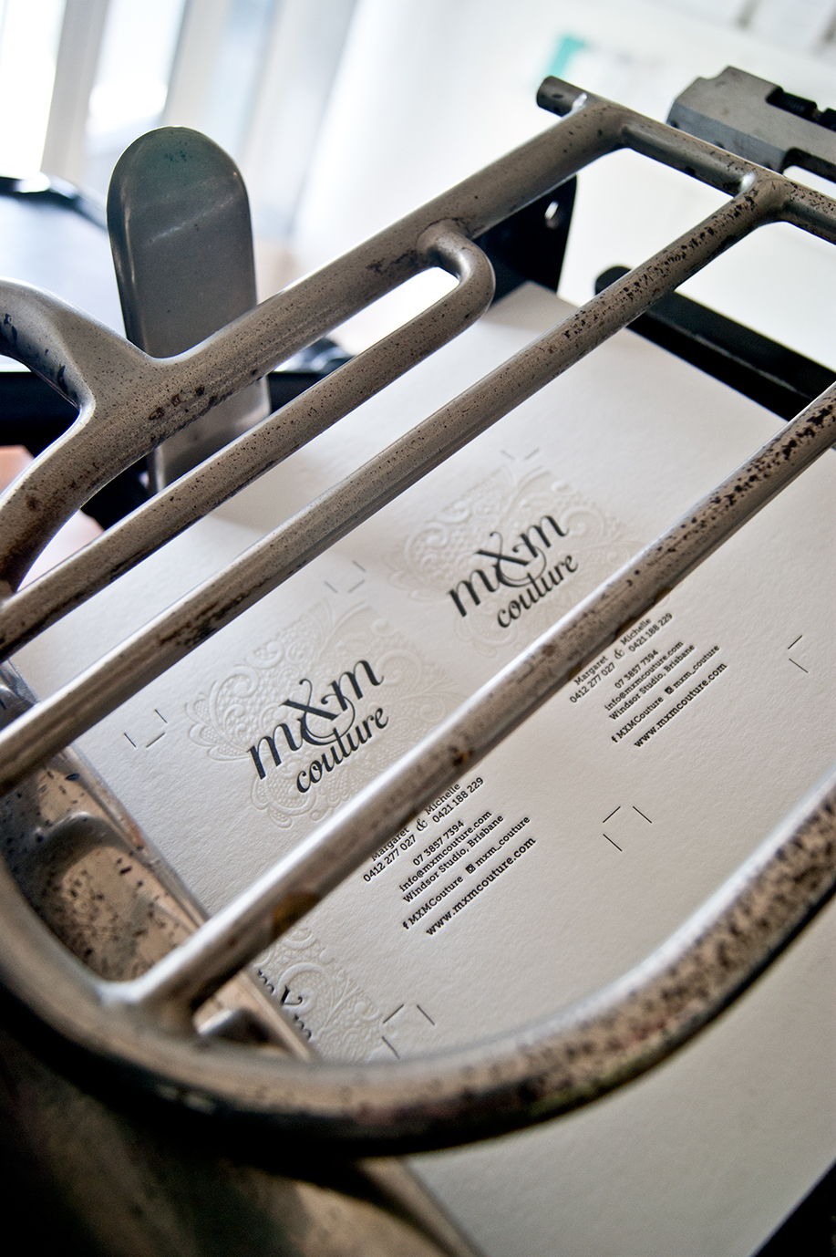 Creative Emporium designed MXM Couture business cards on printing press with new branding in Yesterday Creative Letterpress Studio